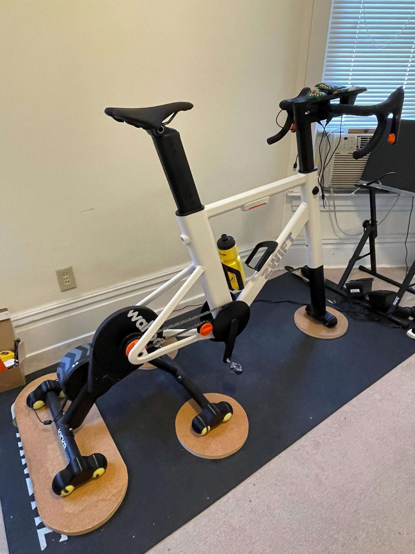 Zwift ride frame with set wahoo kickr core with tennis ball rocker feet