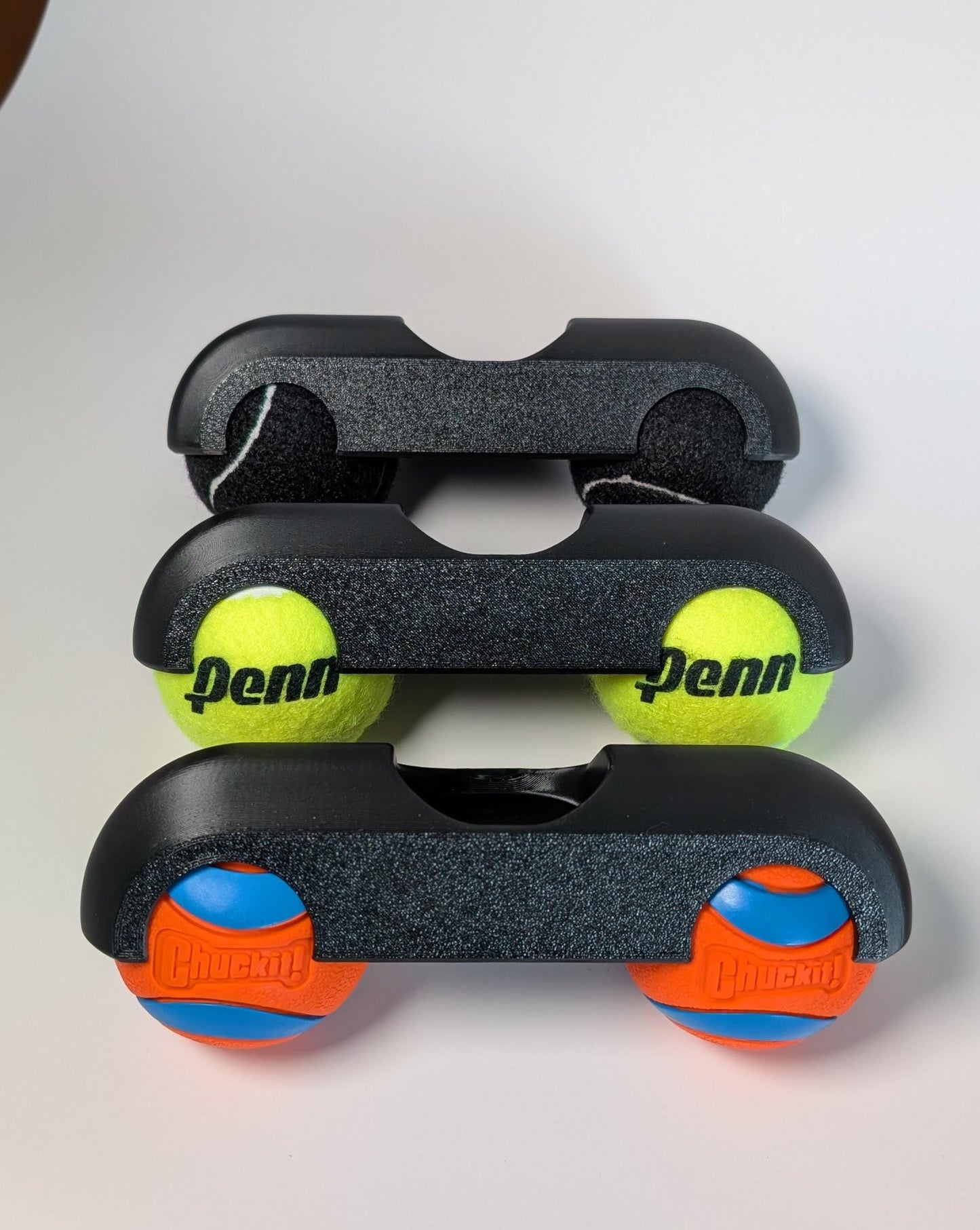 Zwift ride front rocker feet with black yellow and chuck-it balls on a white background
