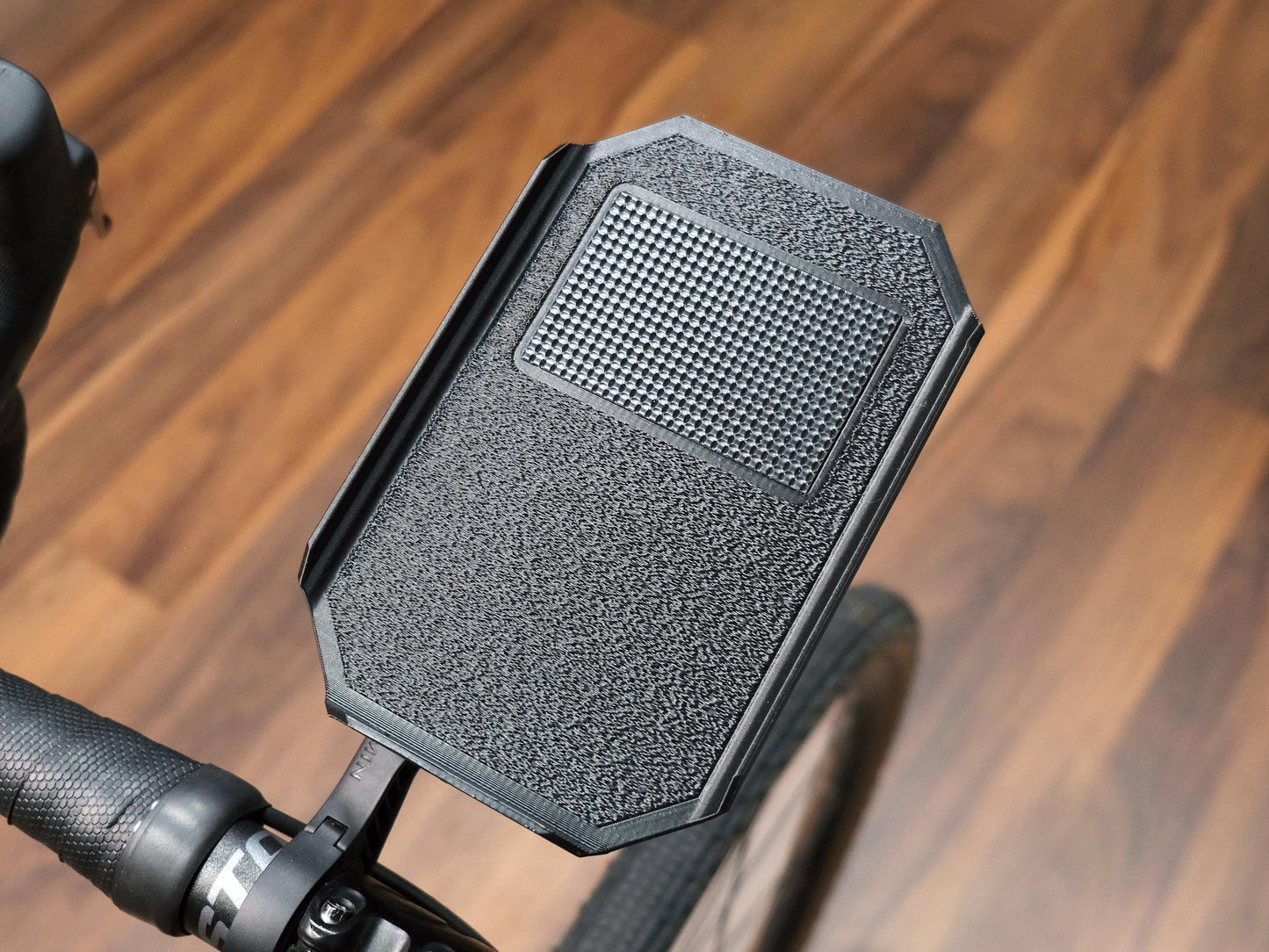 A trainer tray that fits garmin and wahoo mounts with a grippy textured surface
