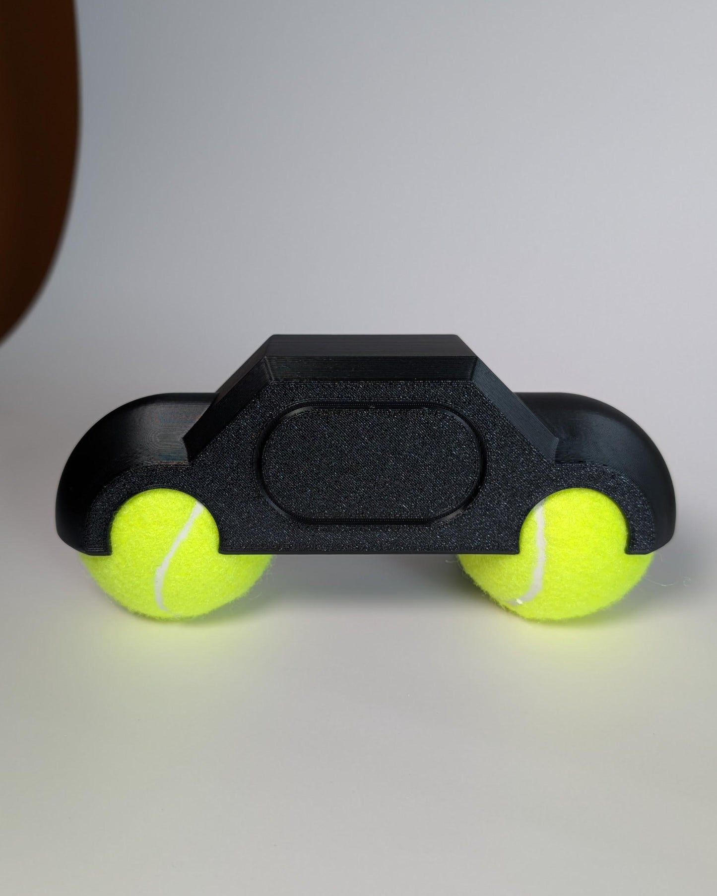 zwift hub one rocker feet with yellow tennis balls on a white background