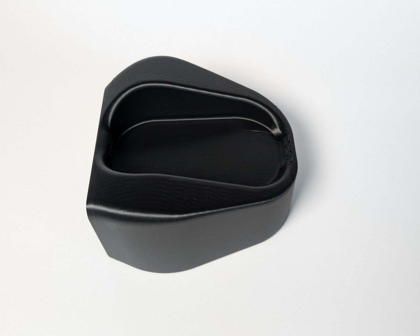Black plastic component on a white background