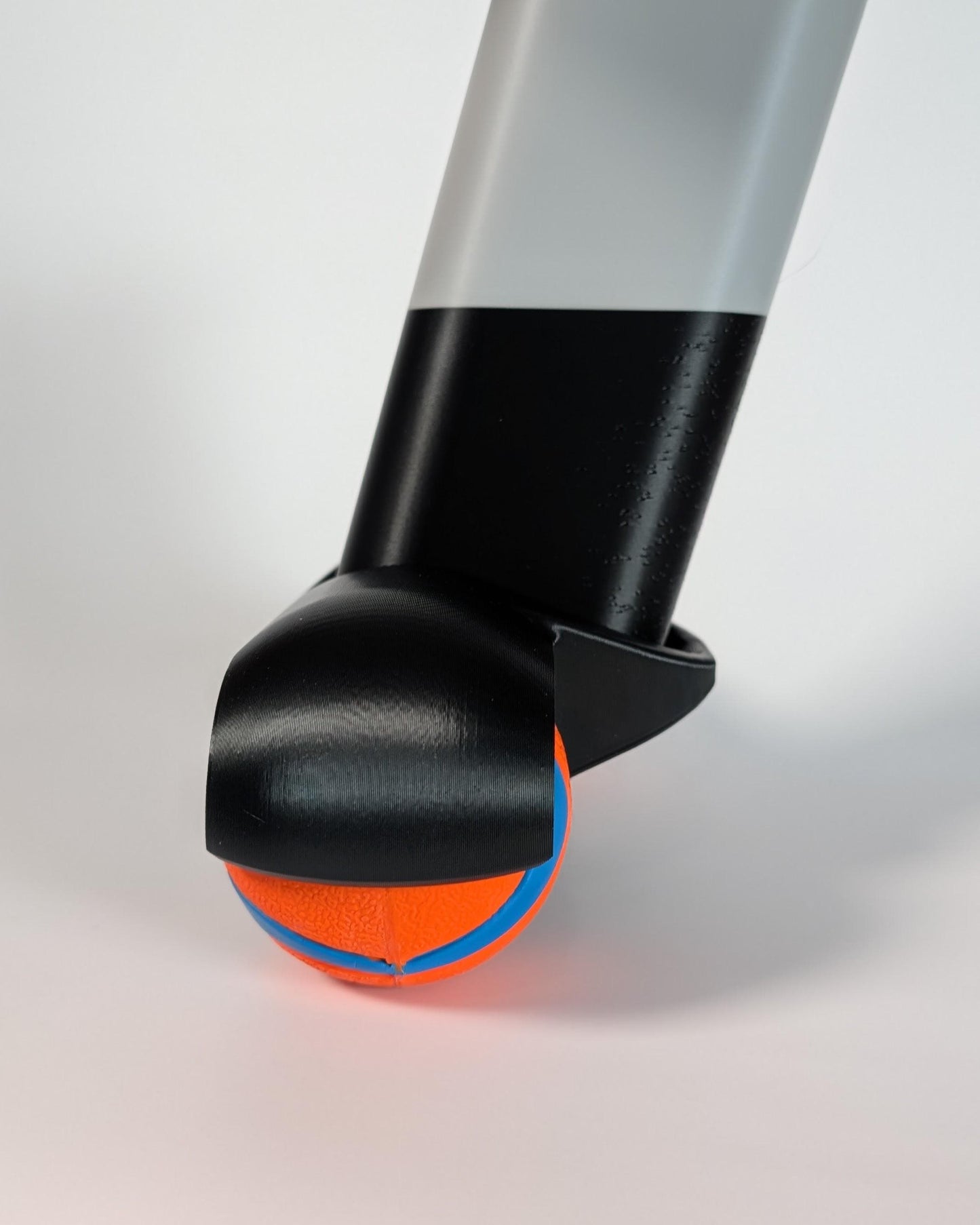 close-up of a zwift ride rocker foot with chuck-it balls on a white background