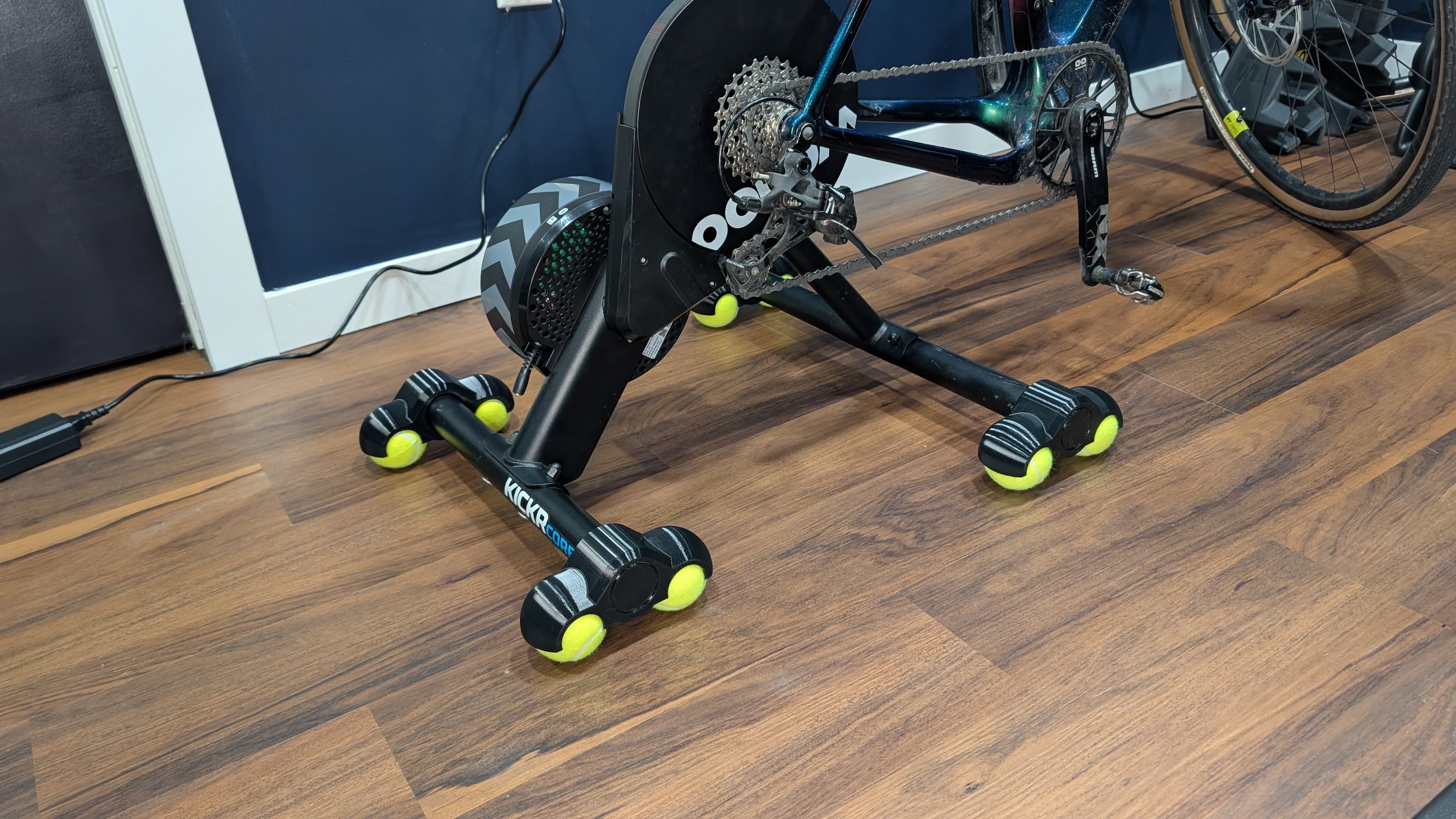 Bike trainer on a wooden floor with rocker feet installed