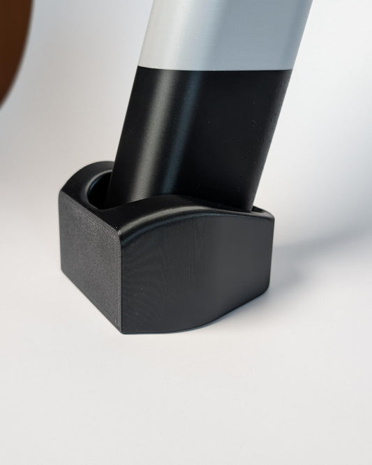 Close-up of a black plastic block on a white background